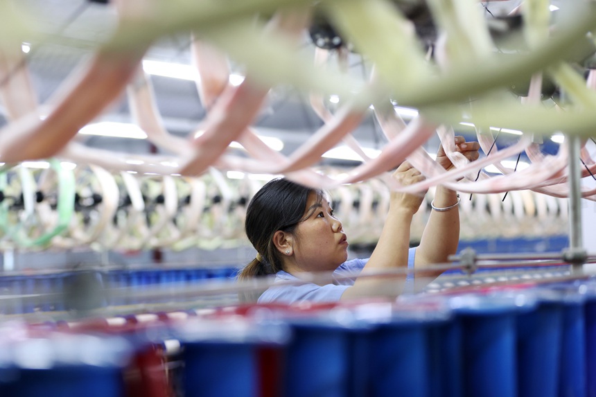 丝绸纺织女工在生产车间忙碌。杨敏摄